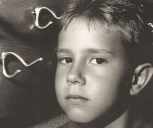 Child at eye level with a protruding metal coat hook